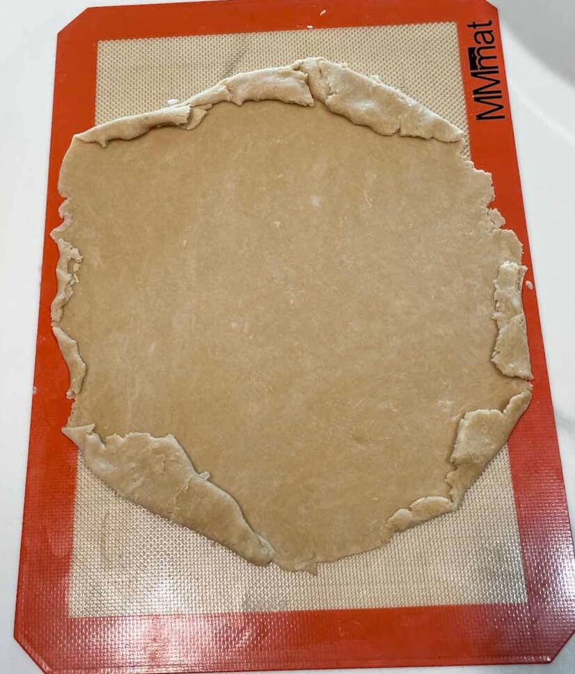 rolled out dough on a silicone mat to make homemade dairy free egg free apple pie crust