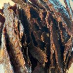 dehydrated homemade beef jerky in a glass jar